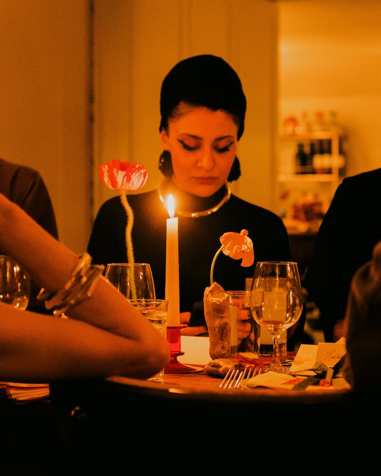 Guest in profile at Is This Seat Taken? — candlelight and poppies